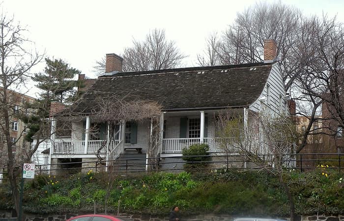 The Dyckman House farmhouse on its small hillock beside Broadway in Inwood, Manhattan