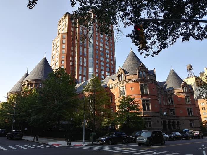 Exterior of the former New York Cancer Hospital, a red brick building with conical towers