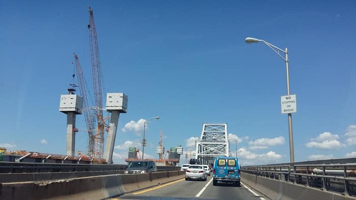 The westbound span of the old Goethals Bridge next to the construction of the new bridge