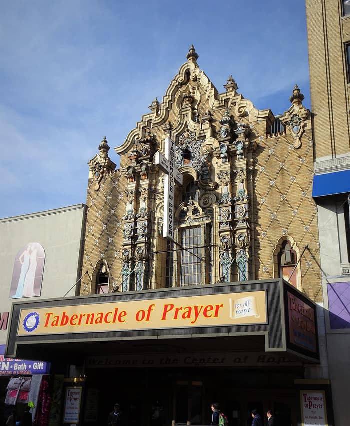 Brick-and-terracotta facade of the former Loew’s Valencia Theatre on Jamaica Avenue in Queens in sunlight