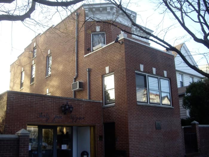 The brick Louis Armstrong House on 107th Street in Corona, Queens